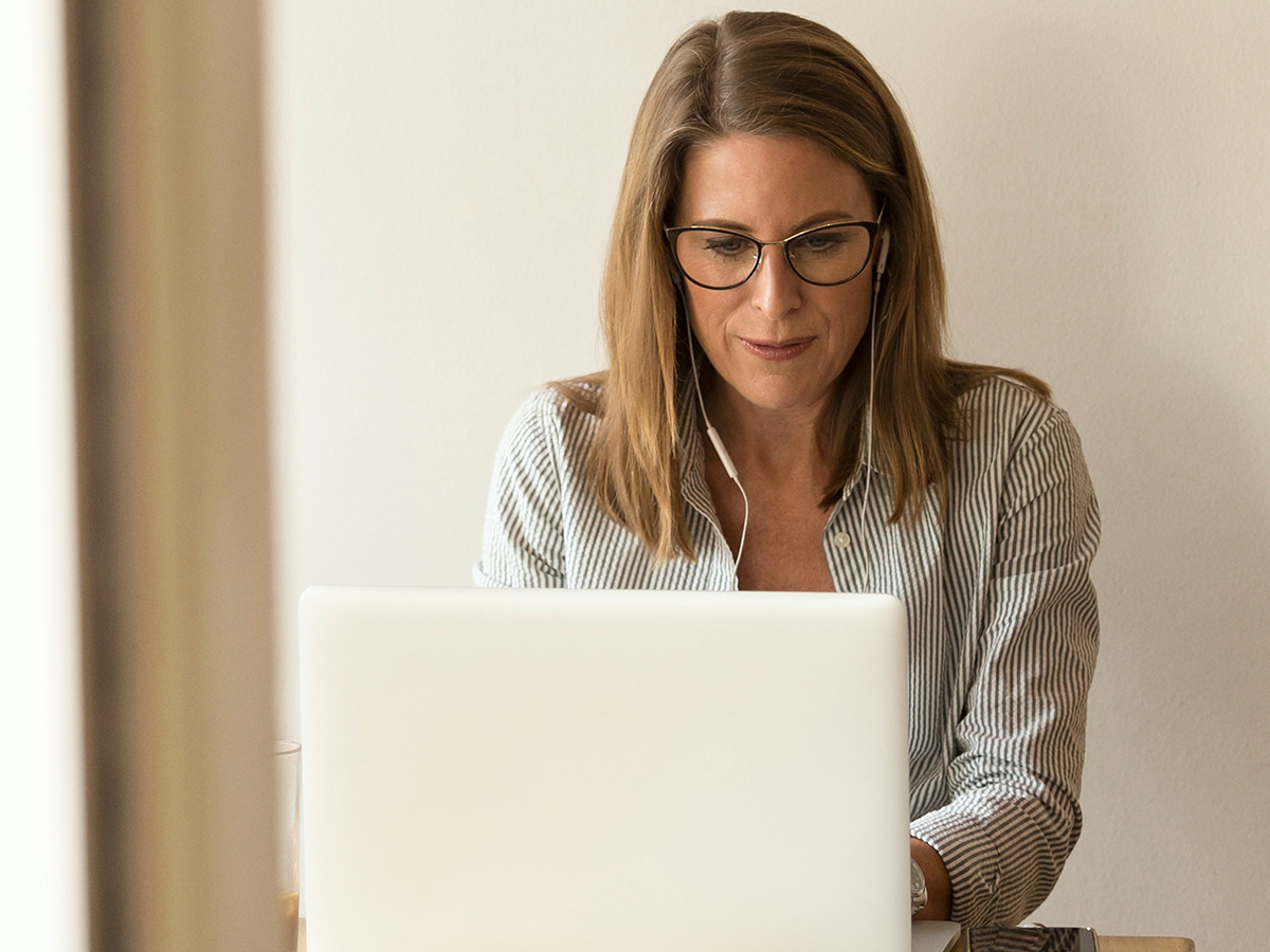 A woman typing on a laptop.