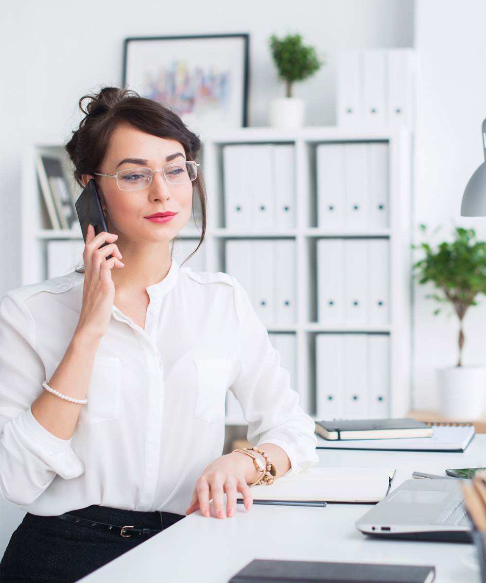 Woman on computer and phone