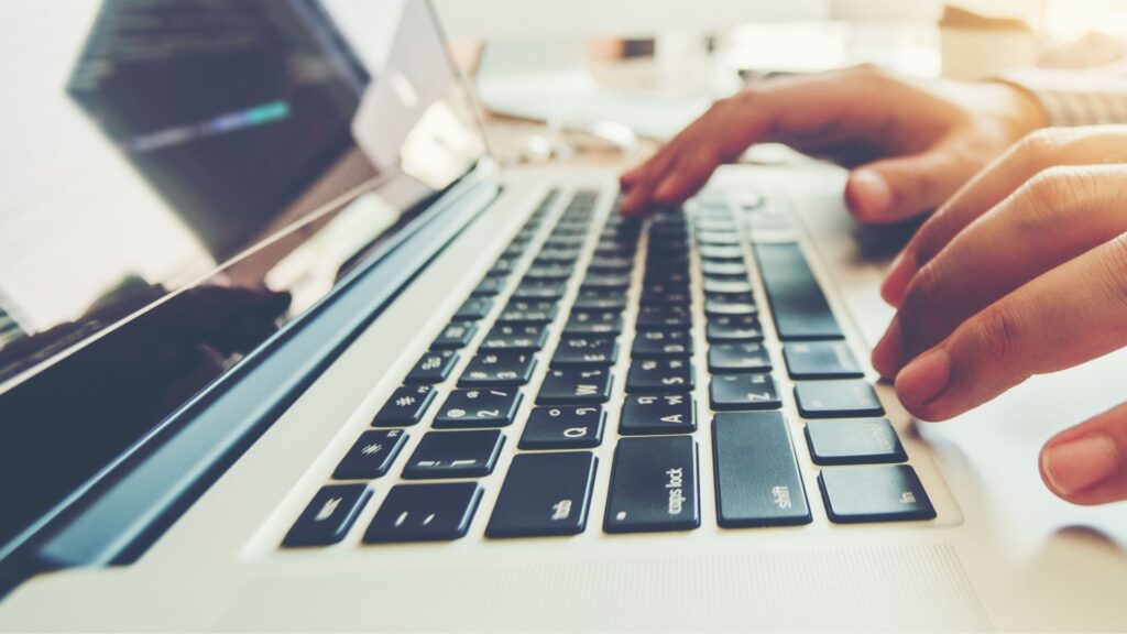 Close up of someone working on a laptop computer