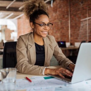 woman smiling working at a computer