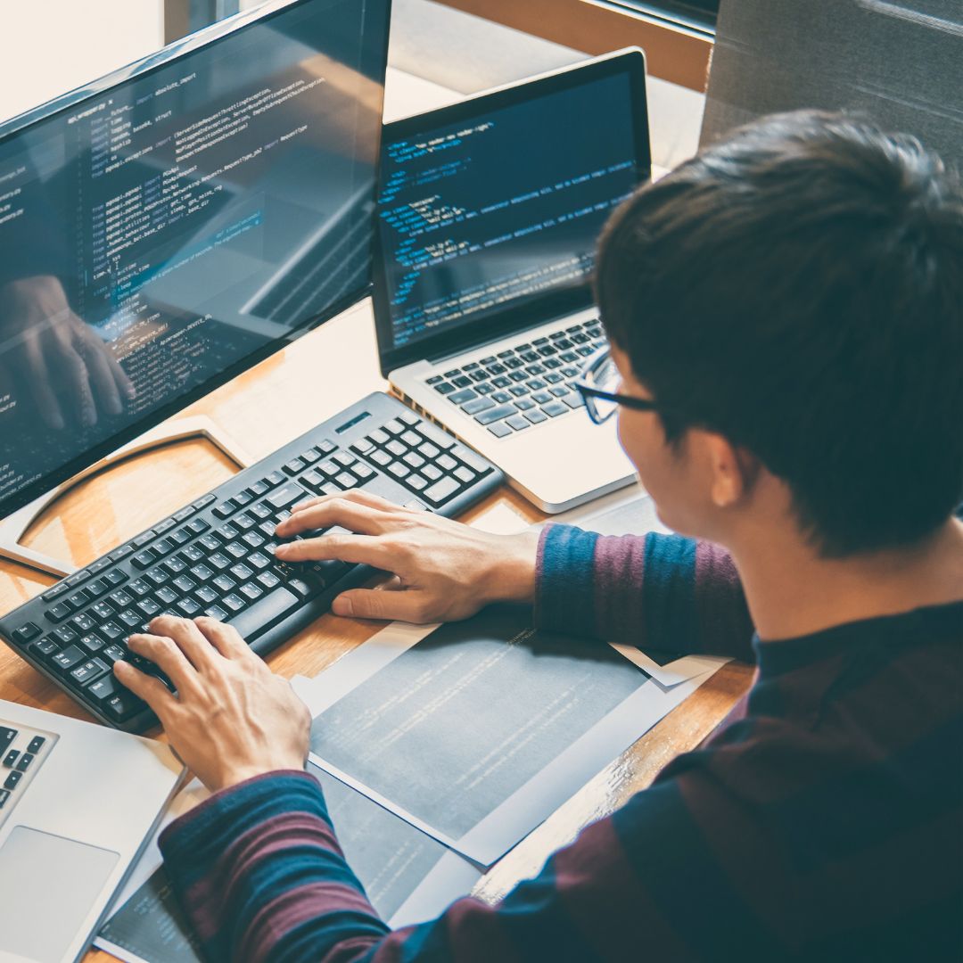 a man working on multiple screens